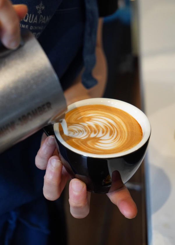 Latte art being poured into a coffee at Croccante & Co