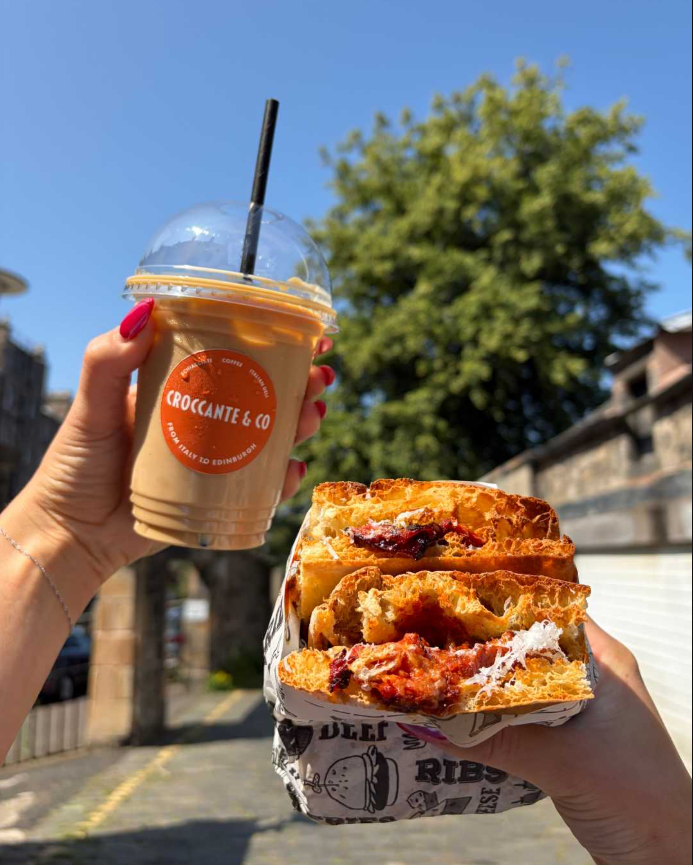 A schiacciata and branded iced coffee held outdoors in Edinburgh
